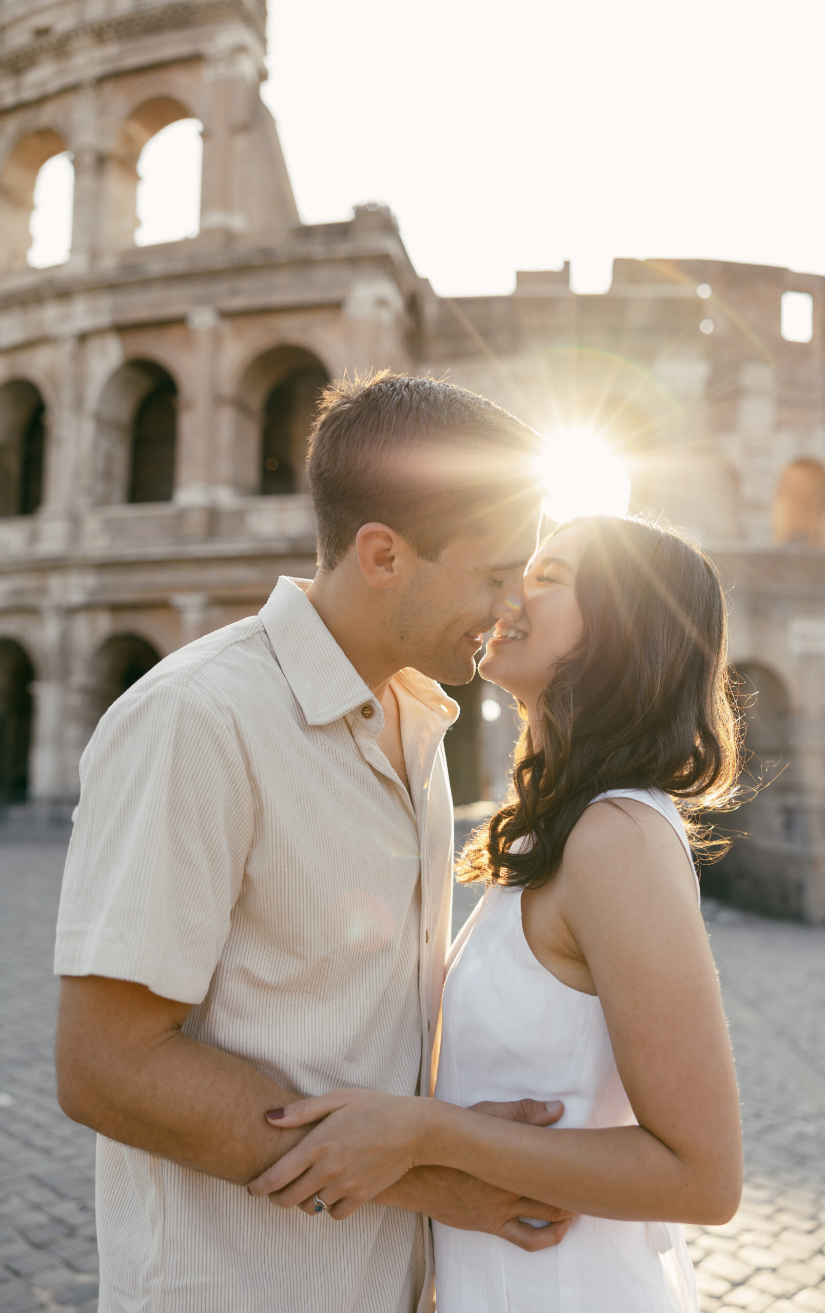 Couple kisses at the Colosseum in Rome, Italy