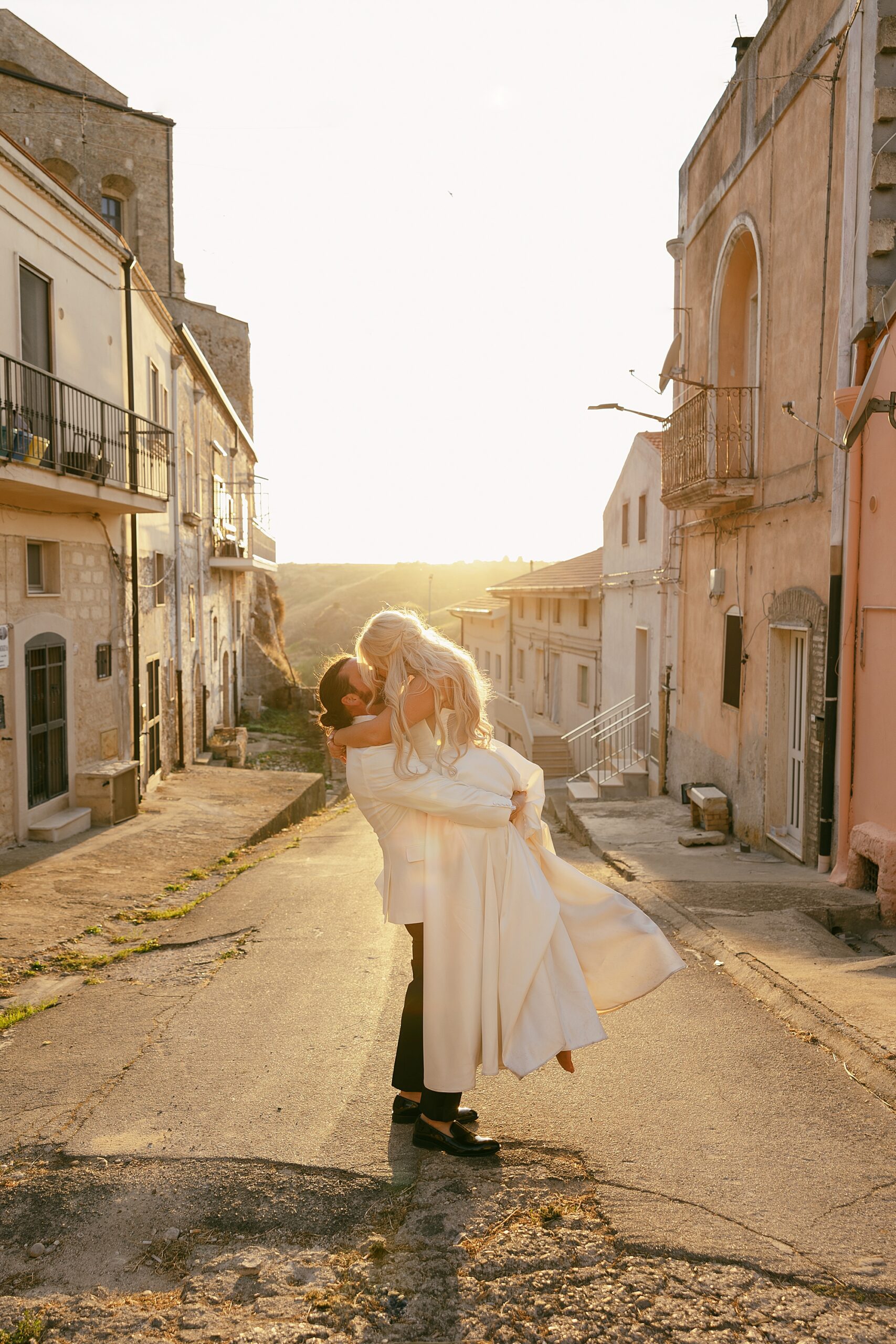 bride and groom kiss in a small town in italy