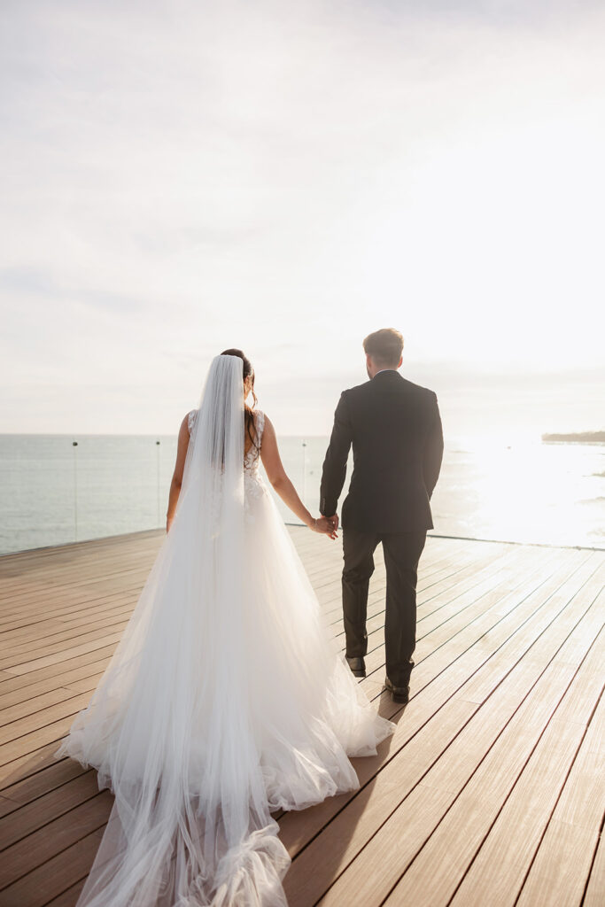 couple holding hands during sunset photos