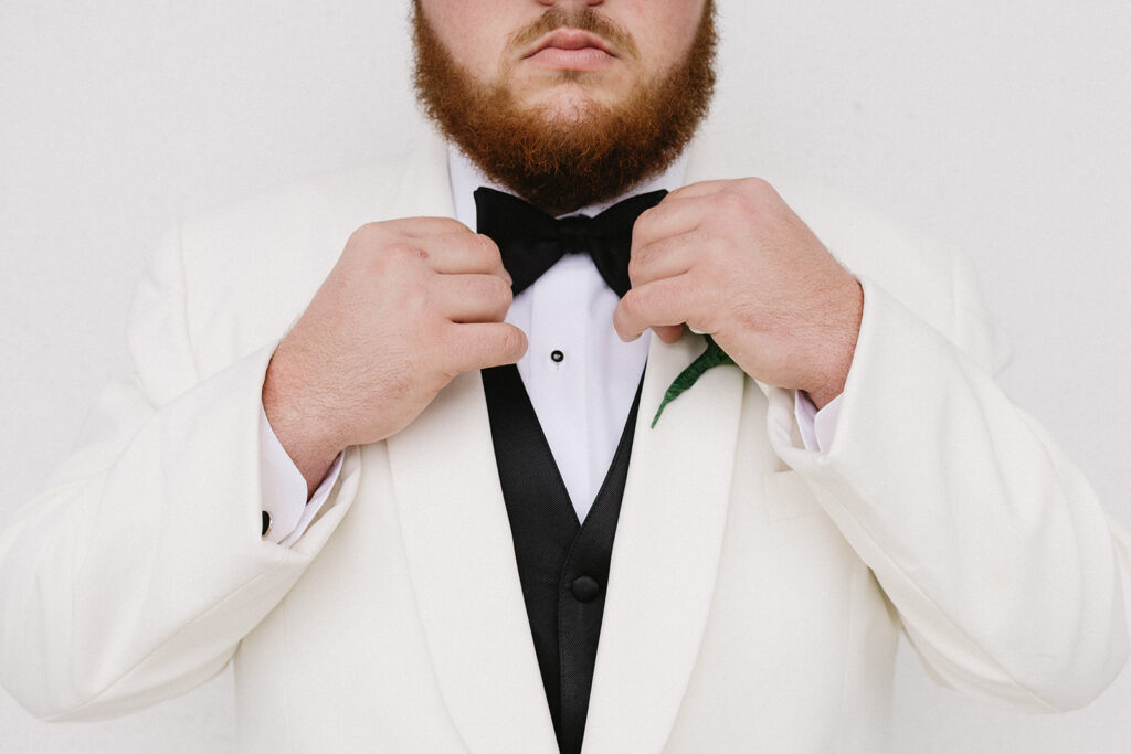 groom getting ready for wedding from a spanish moss wedding