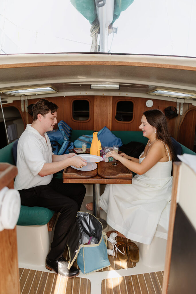 A romantic sailboat proposal captured with the couple posing together on deck.
