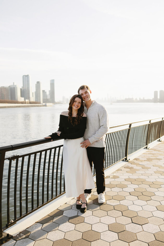 A couple enjoying a relaxed and stylish engagement shoot in New York City, with the city as their backdrop.
