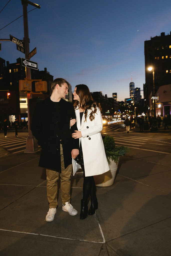 Two people in love posing for modern engagement photos in the heart of NYC, capturing their connection in a natural way.
