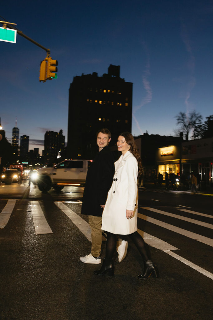 A couple sharing a candid moment during their engagement session in New York City, surrounded by the energy of the streets.
