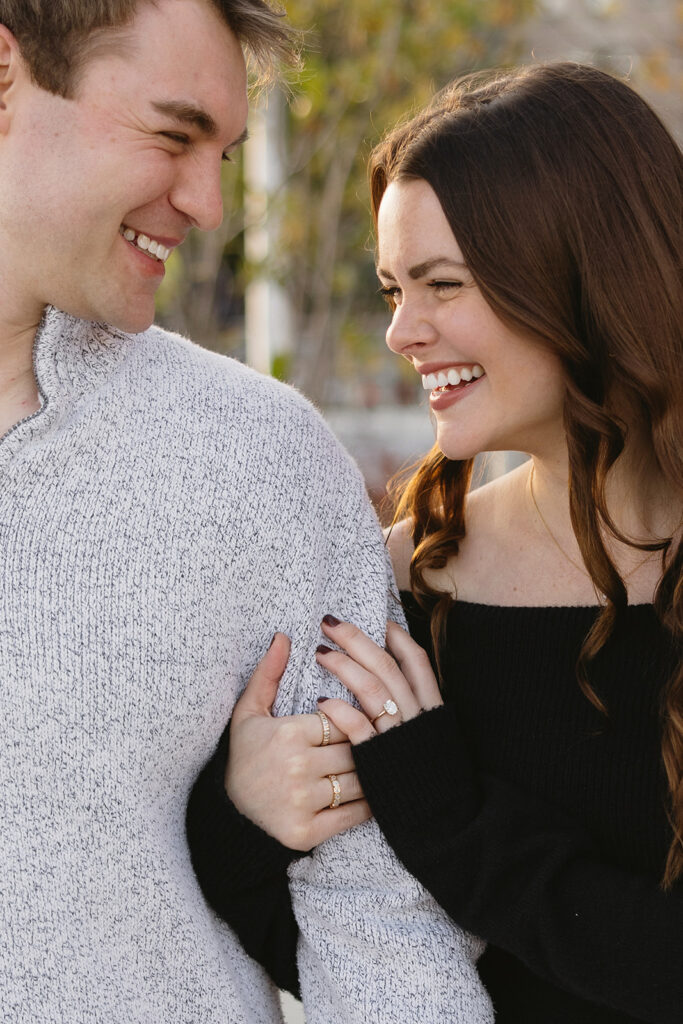 A couple sharing a candid moment during their engagement session in New York City, surrounded by the energy of the streets.
