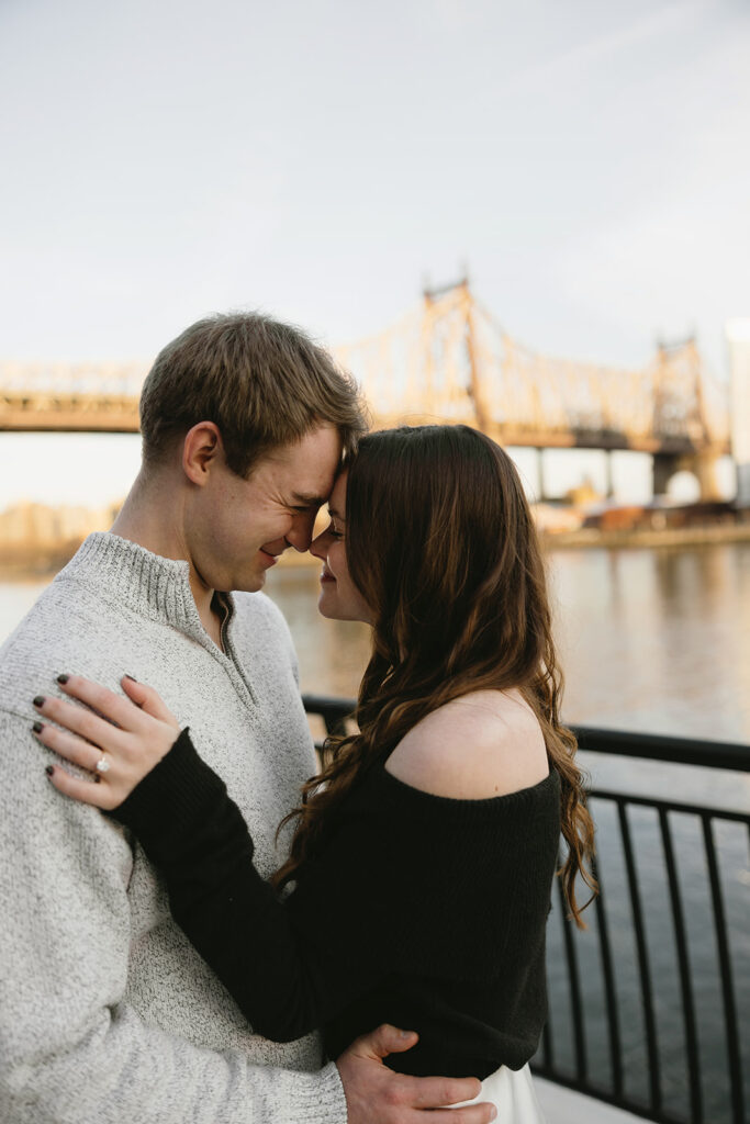 Two people in love posing for modern engagement photos in the heart of NYC, capturing their connection in a natural way.
