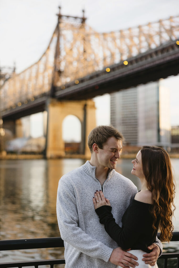 Two people in love posing for modern engagement photos in the heart of NYC, capturing their connection in a natural way.
