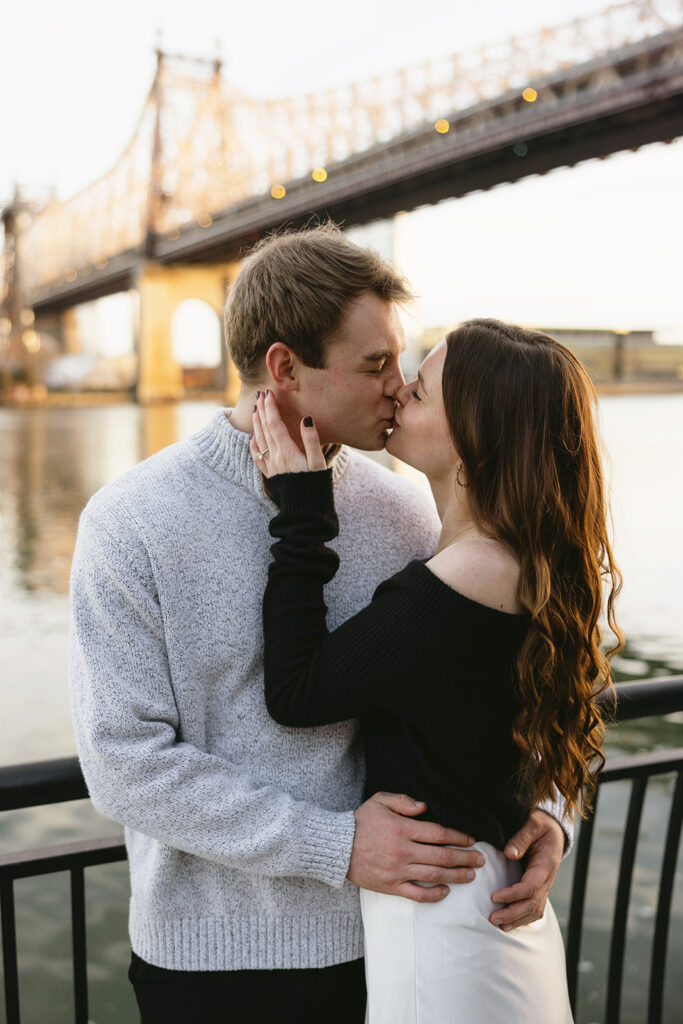 Two people in love posing for modern engagement photos in the heart of NYC, capturing their connection in a natural way.
