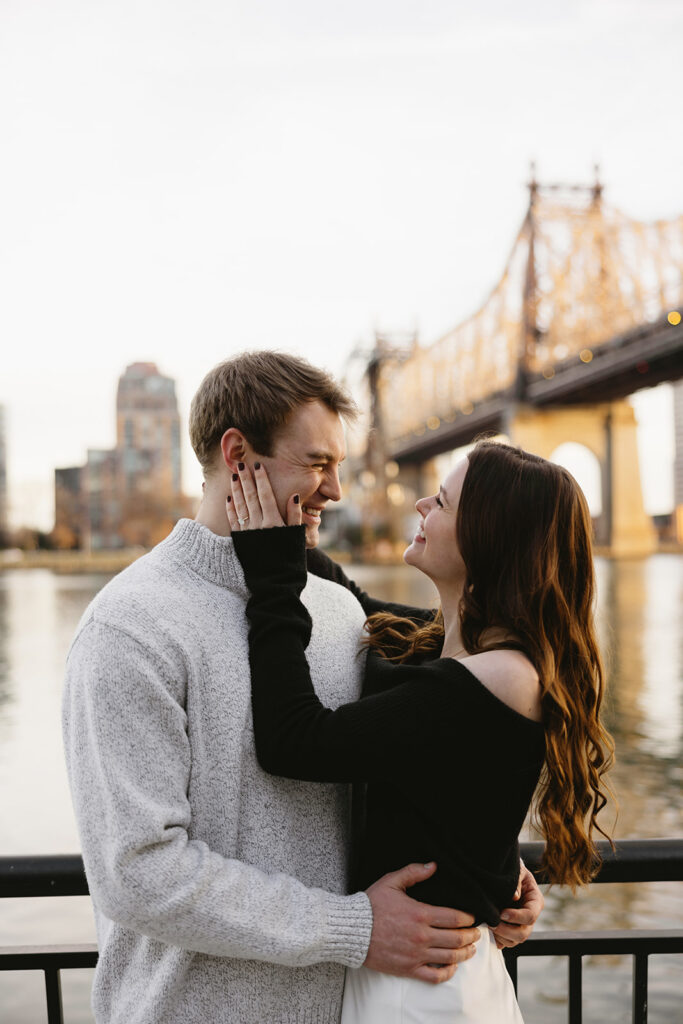 A couple enjoying a relaxed and stylish engagement shoot in New York City, with the city as their backdrop.