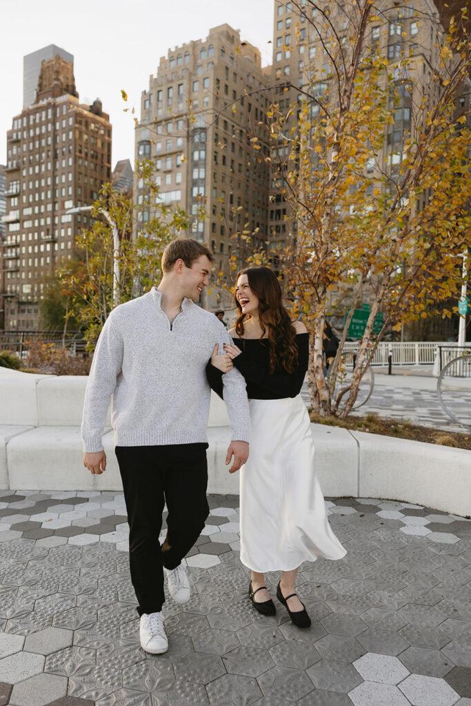 A couple sharing a candid moment during their engagement session in New York City, surrounded by the energy of the streets.
