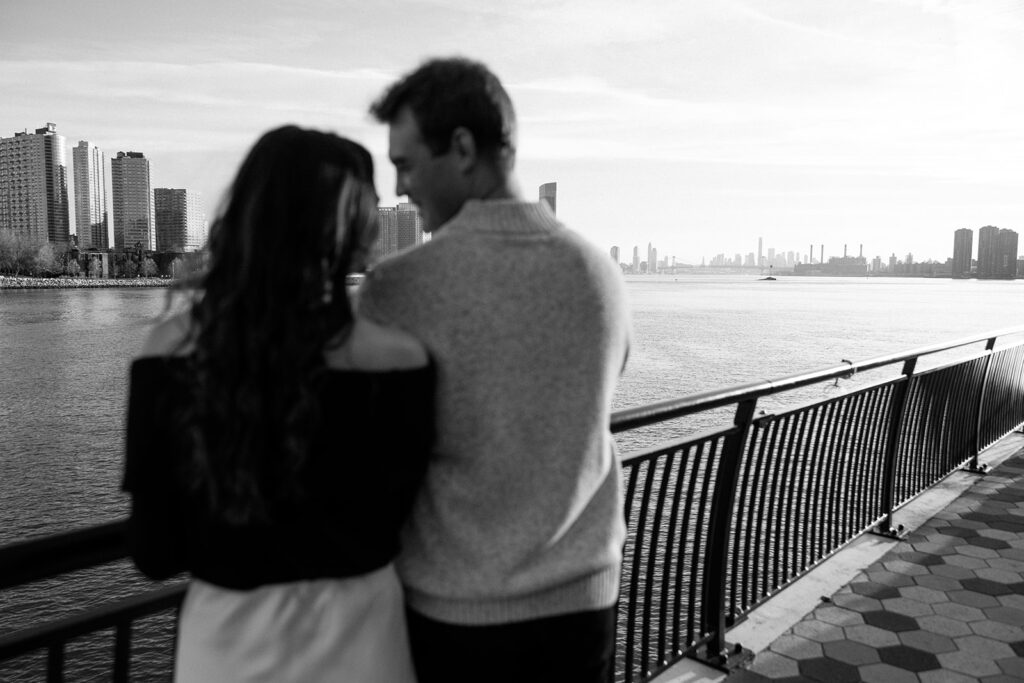 A couple sharing a candid moment during their engagement session in New York City, surrounded by the energy of the streets.
