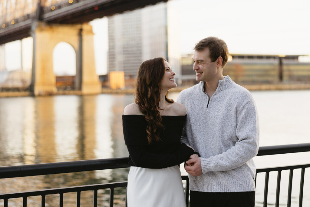 A couple enjoying a relaxed and stylish engagement shoot in New York City, with the city as their backdrop.
