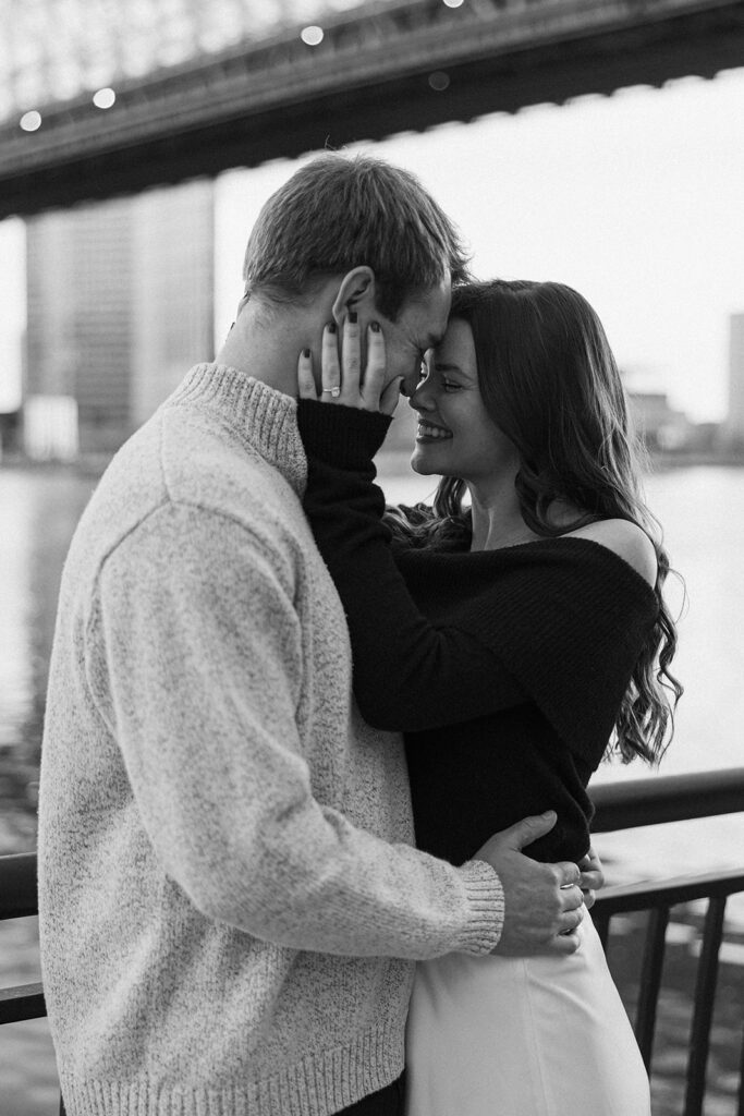 Two people in love posing for modern engagement photos in the heart of NYC, capturing their connection in a natural way.
