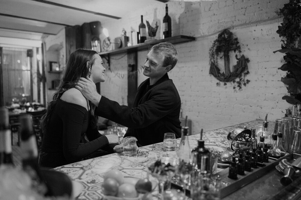 Two people in love posing for modern engagement photos in the heart of NYC, capturing their connection in a natural way.
