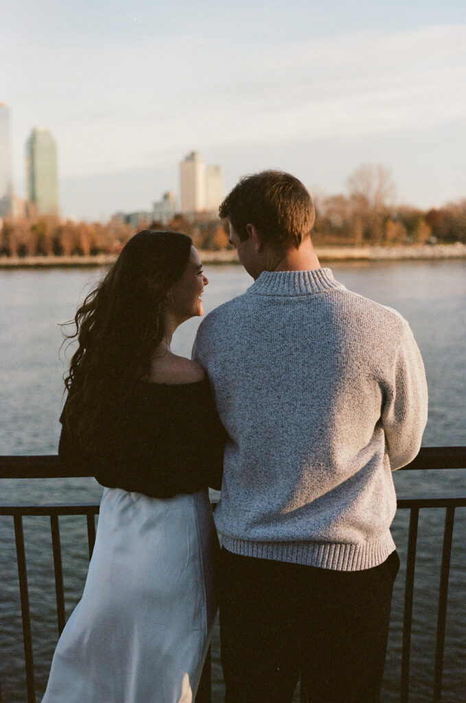 A couple enjoying a relaxed and stylish engagement shoot in New York City, with the city as their backdrop.
