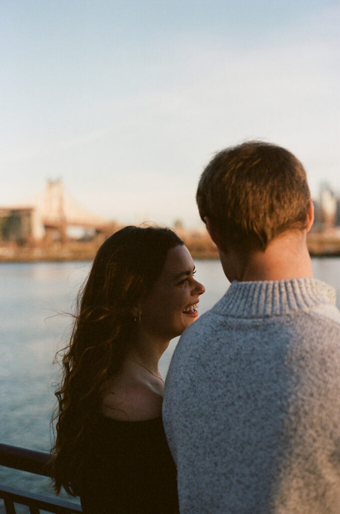 A couple enjoying a relaxed and stylish engagement shoot in New York City, with the city as their backdrop.
