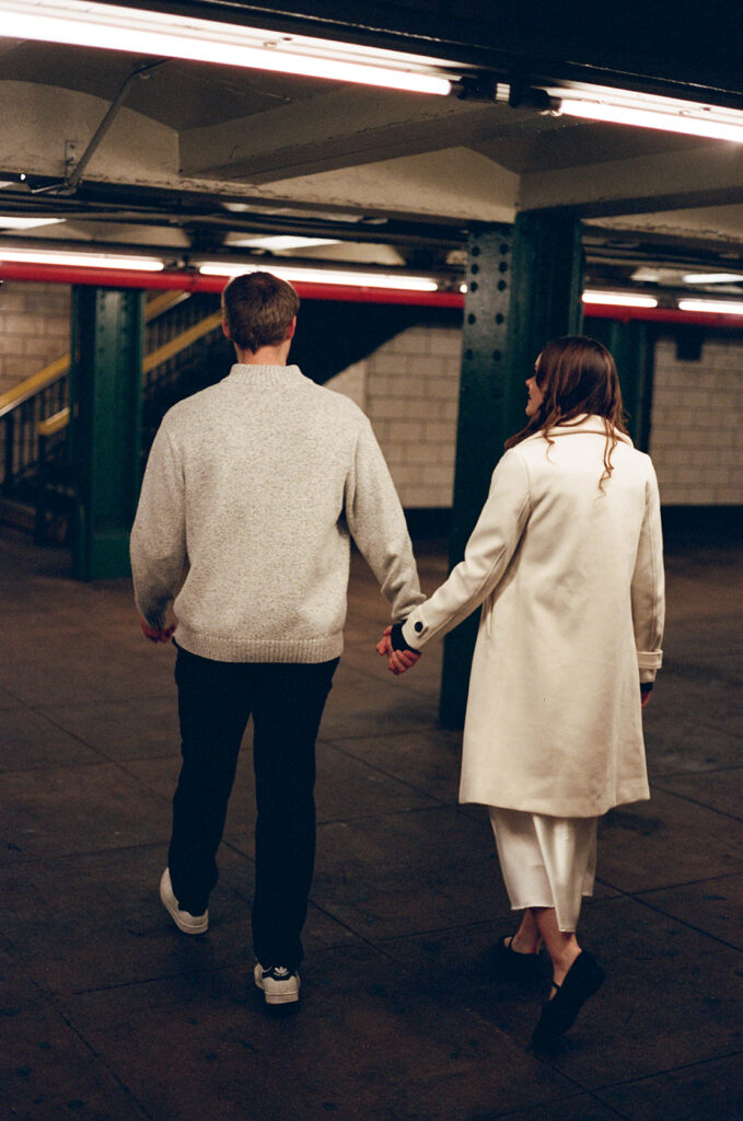 A couple enjoying a relaxed and stylish engagement shoot in New York City, with the city as their backdrop.
