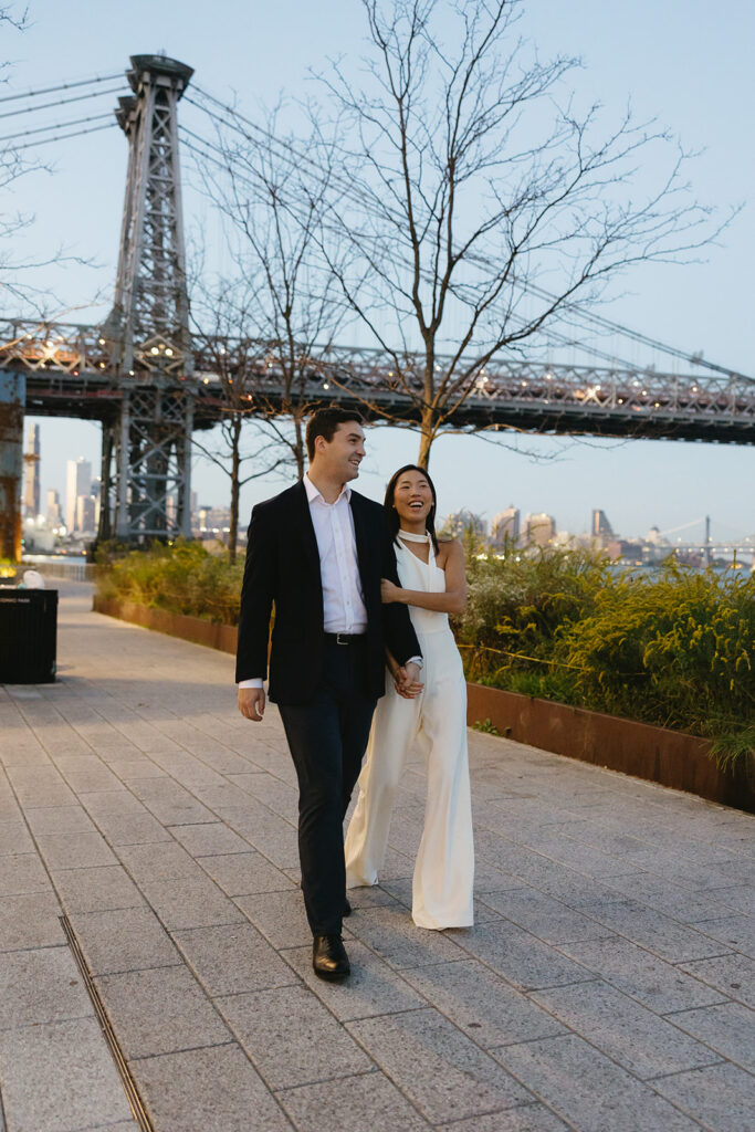 A couple enjoying a quiet, intimate engagement session at Domino Park in Brooklyn, framed by the dreamy blue hour glow.
