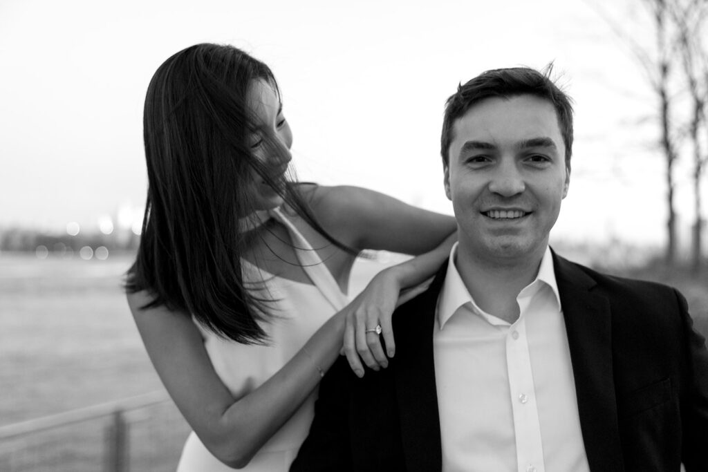 A couple sharing romantic moments during their early morning engagement session at Domino Park, Brooklyn, with the soft blue hour light setting the scene.
