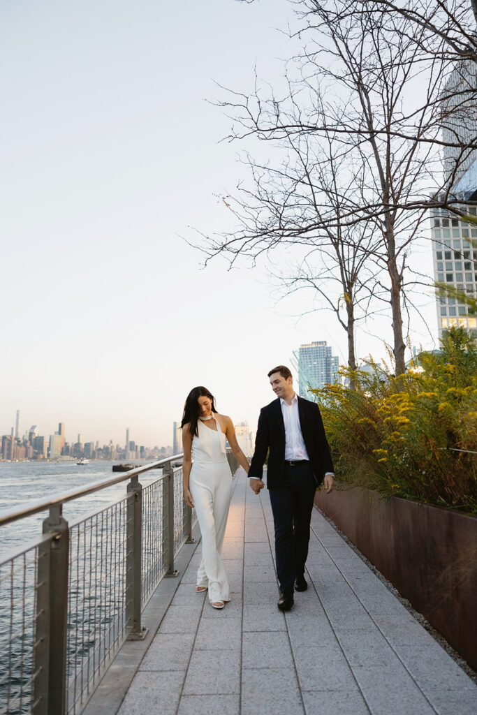 A couple sharing romantic moments during their early morning engagement session at Domino Park, Brooklyn, with the soft blue hour light setting the scene.
