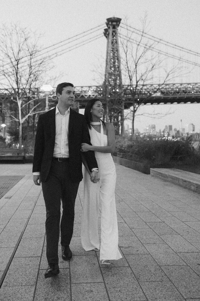 A couple enjoying a quiet, intimate engagement session at Domino Park in Brooklyn, framed by the dreamy blue hour glow.