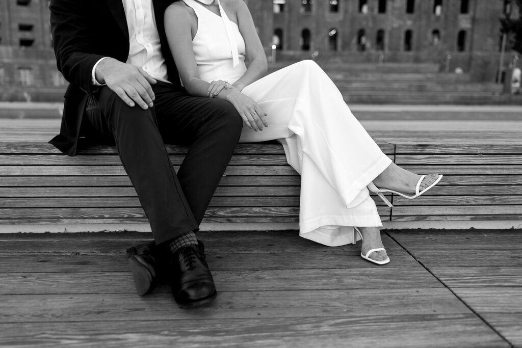 A couple sharing romantic moments during their early morning engagement session at Domino Park, Brooklyn, with the soft blue hour light setting the scene.
