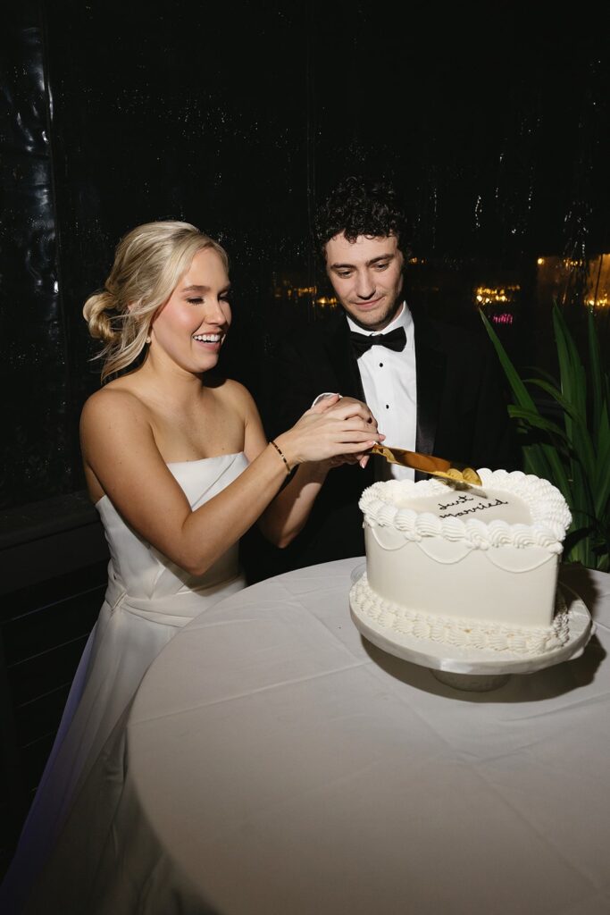 Bride and groom cutting their wedding cake