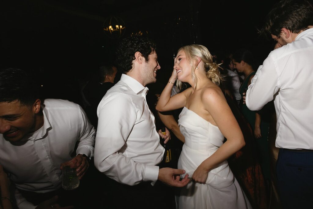 bride and groom dancing during their rainy day wedding reception.