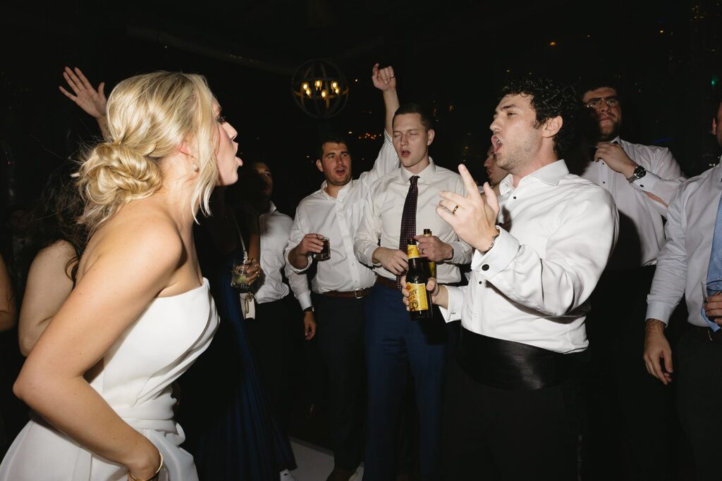 bride and groom dancing during their rainy day wedding reception.