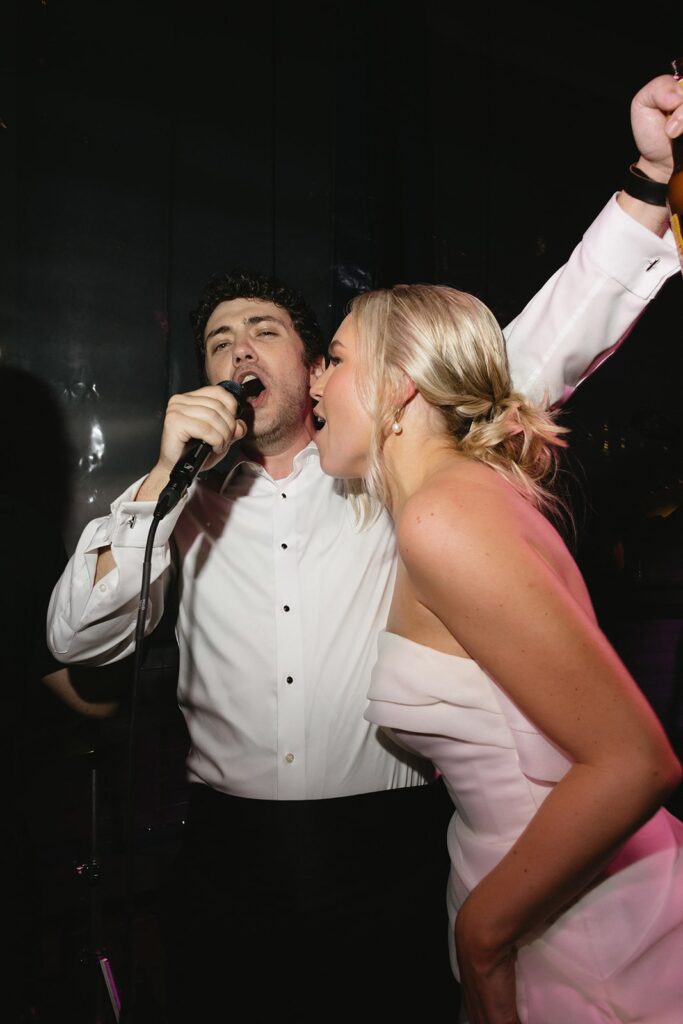 bride and groom dancing during their rainy day wedding reception.