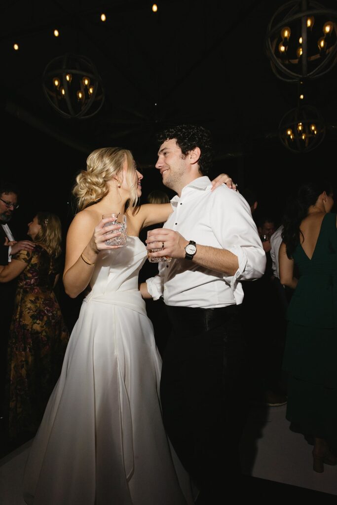 bride and groom dancing during their rainy day wedding reception.