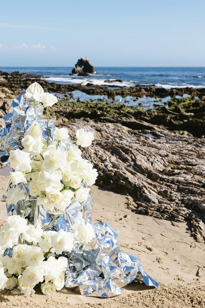 Elegant beach wedding tablescape with metallic details and white florals
