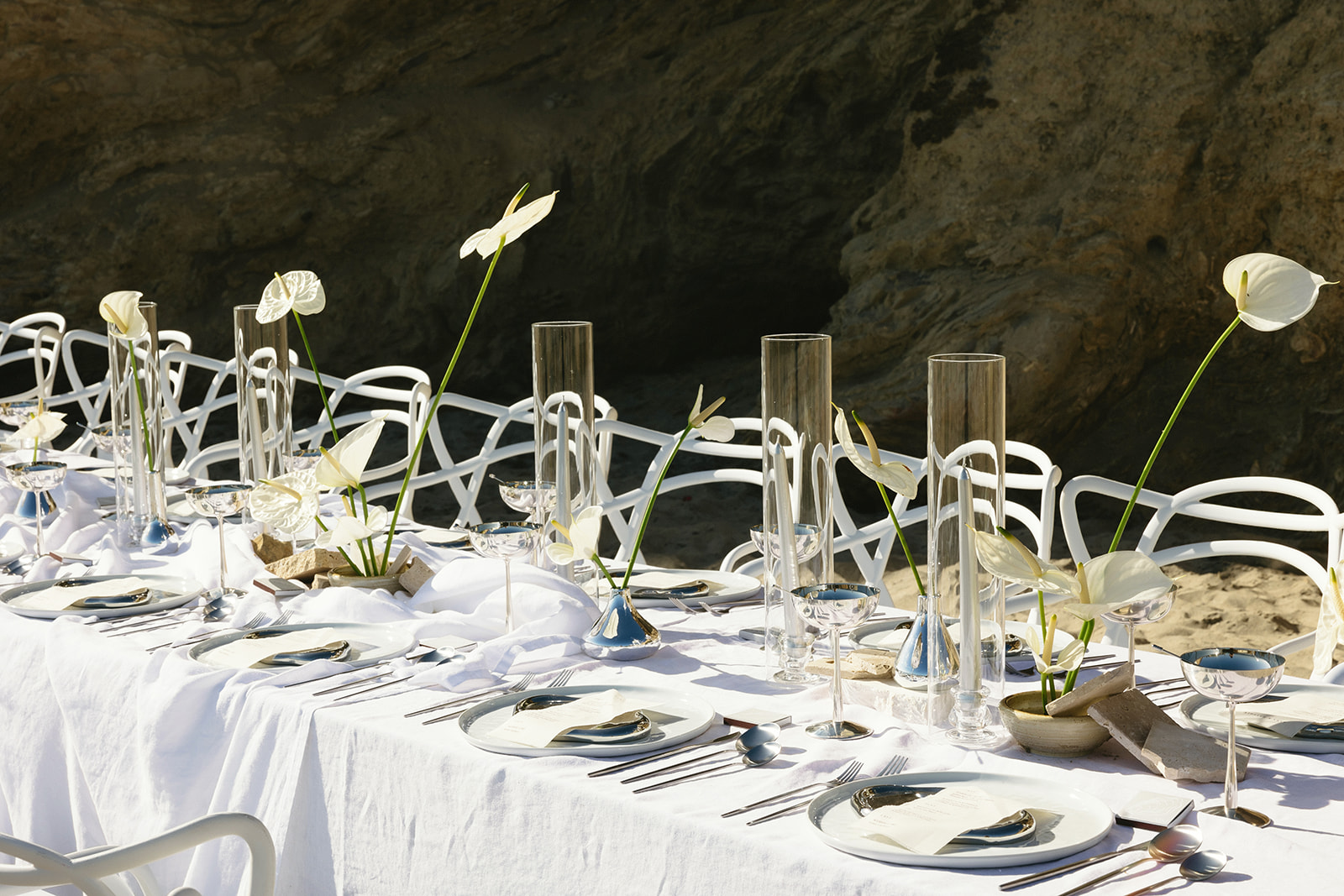 Elegant beach wedding tablescape with metallic details and white florals