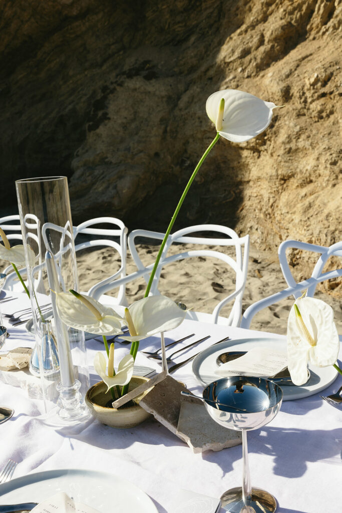 Chic seaside wedding reception design featuring minimal florals and polished accents
