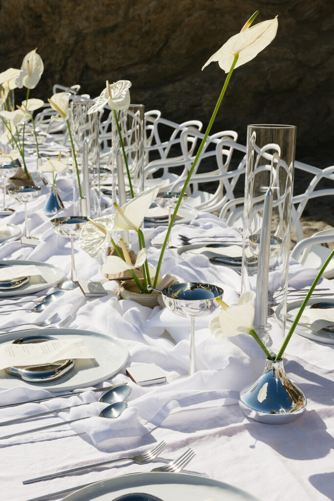 Elegant beach wedding tablescape with metallic details and white florals